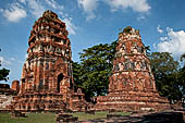 Ayutthaya, Thailand. Wat Mahathat, two auxiliary chedi outside the S-E corner of the enclosure wall. 